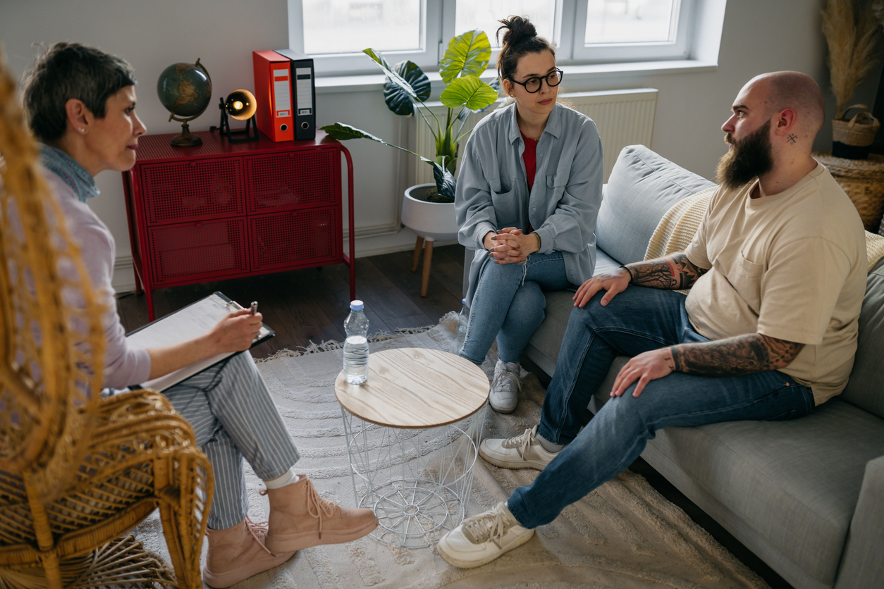A licensed therapist meeting one-on-one with a client in a calm, private therapy office