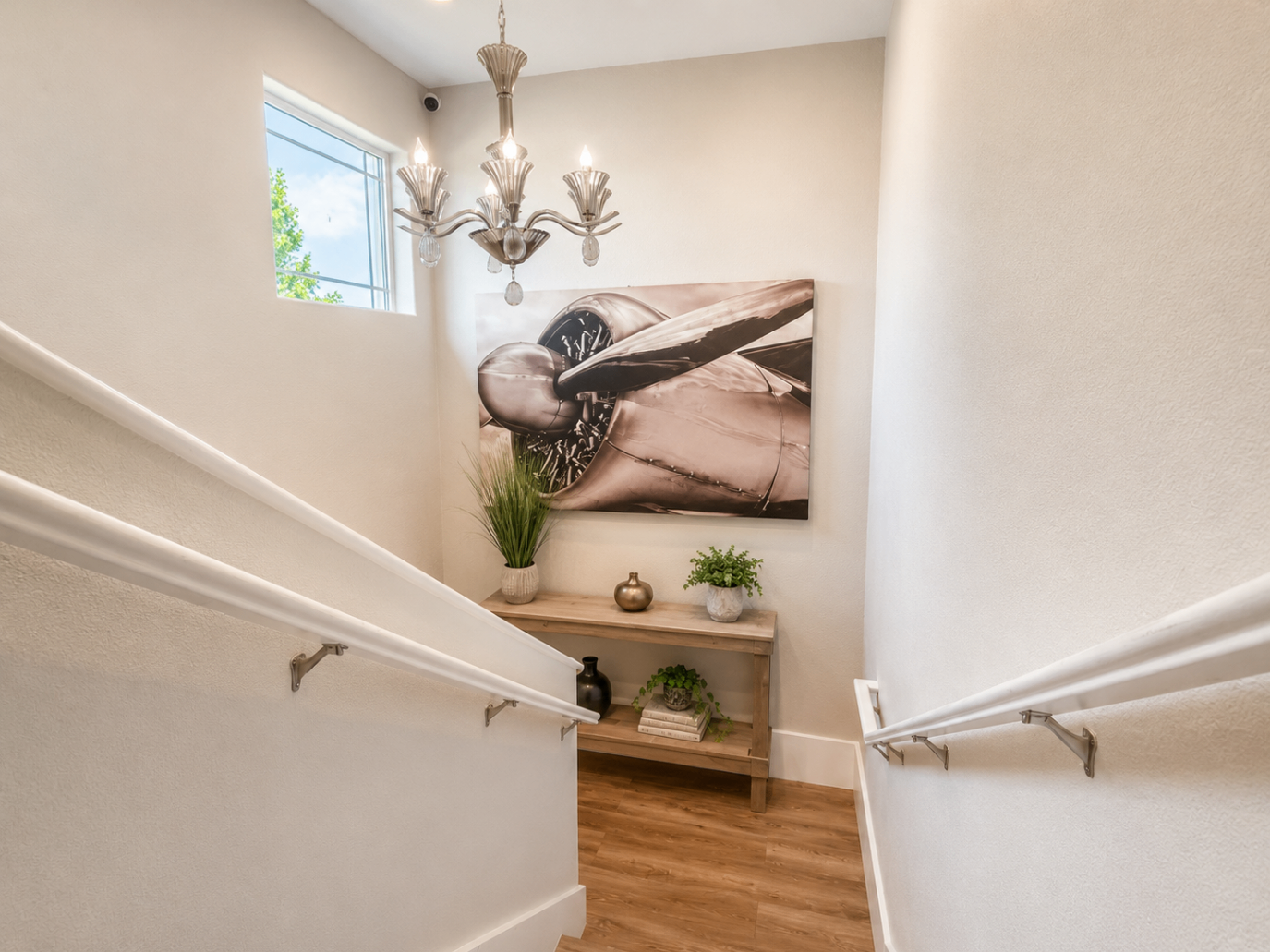 A bright stairway landing at Hangar Two with vintage aviation artwork