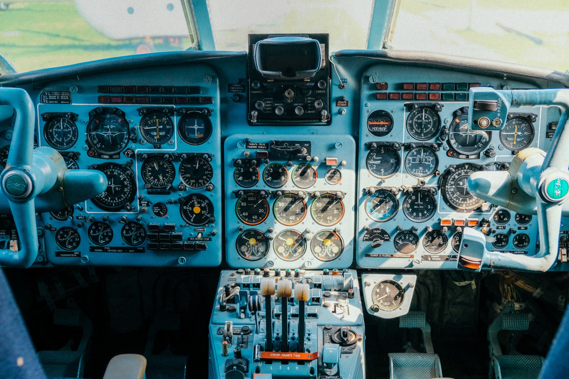 Detailed cockpit instrument panel with rows of analog gauges and controls.