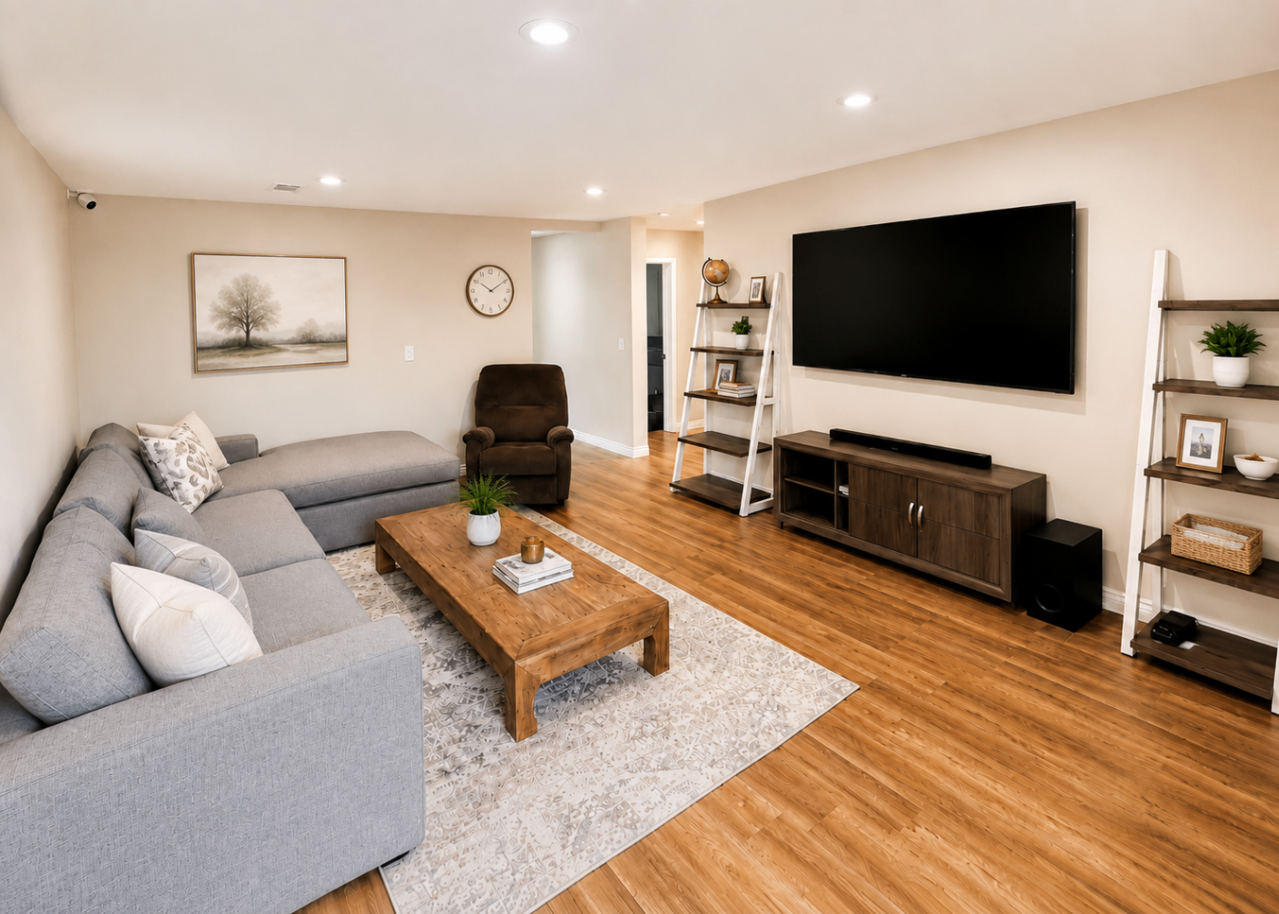 The living room at Hangar Two with a sectional sofa and warm wood floors