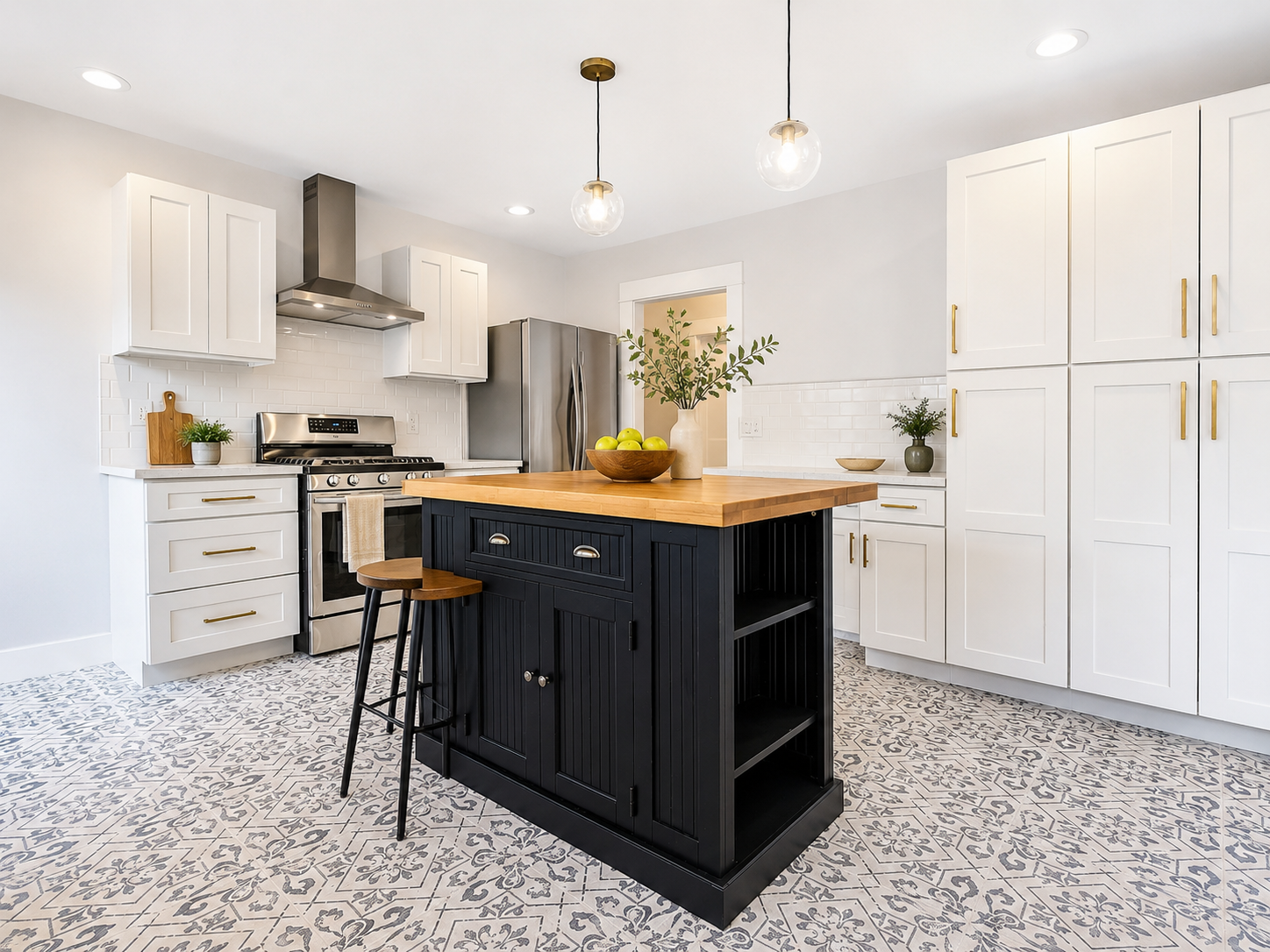 The Ross Home chef's kitchen with white cabinetry and a black island