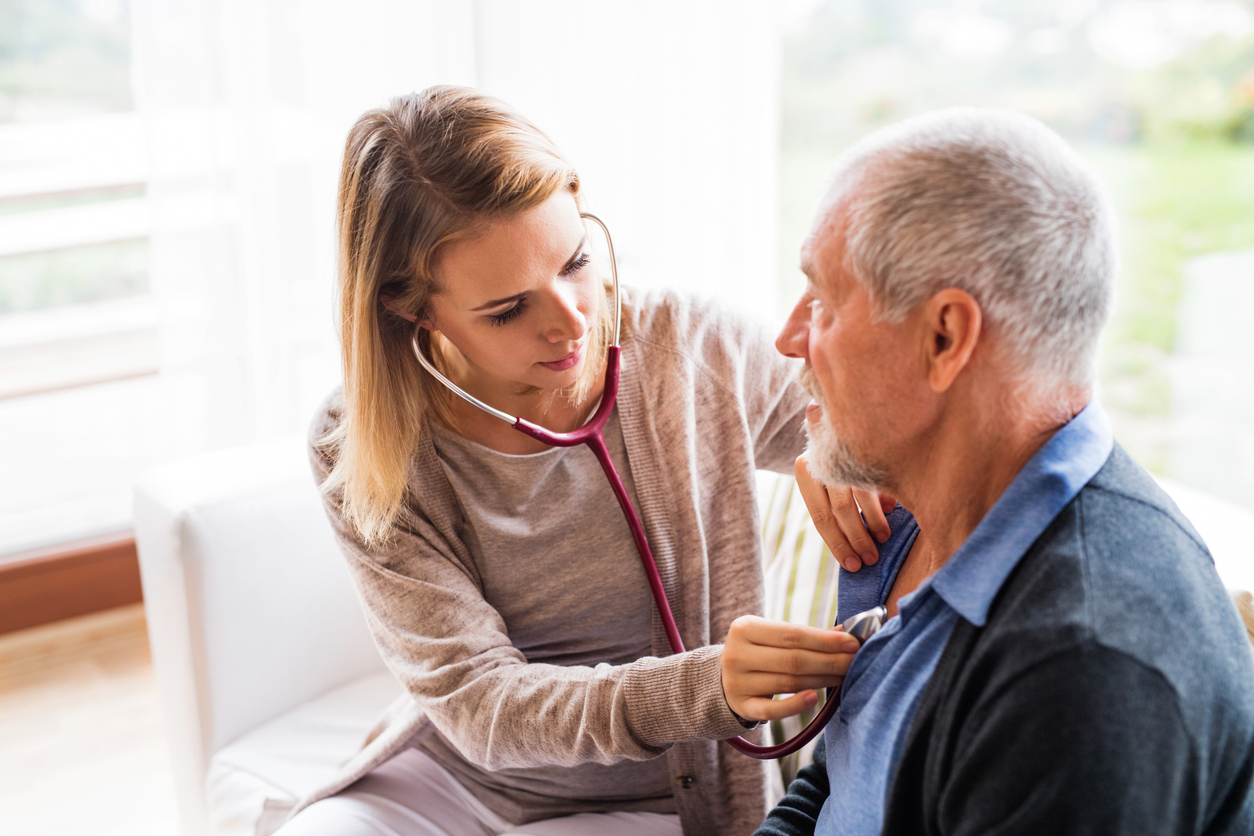 A caring clinician checking on a client in a warm room